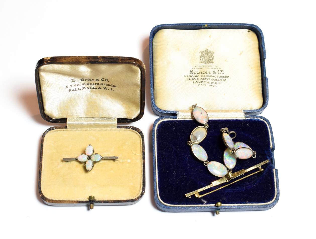 Lot 501 - An opal matrix bracelet, comprised of eight collet set oval cabochon opal matrix plaques,...