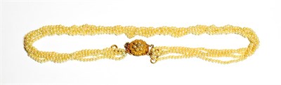 Lot 521 - A four row seed pearl necklace, knotted to a filigree split pearl cluster clasp, length 40.5cm