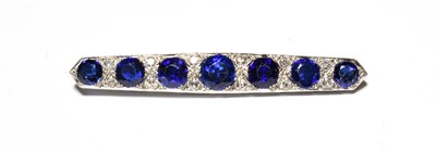 Lot 534 - A synthetic sapphire and diamond brooch, seven graduated synthetic sapphires spaced by pairs of...