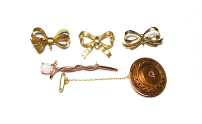 Lot 535 - A ruby and diamond mourning brooch, stamped '15CT'; two 9 carat gold bow brooches; another bow...