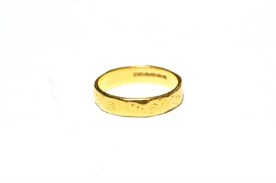 Lot 542 - A 22 carat gold textured band ring, finger size H
