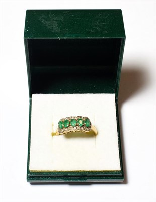 Lot 564 - A 9 carat gold emerald and diamond cluster ring, finger size Q