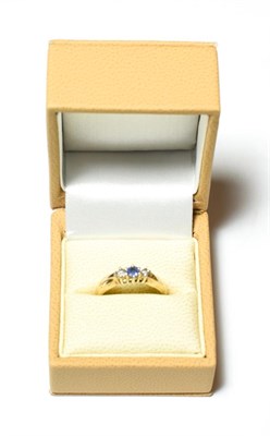Lot 572 - A 9 carat gold sapphire and diamond three stone ring, finger size N