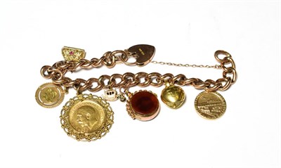 Lot 574 - A curb link charm bracelet, each link stamped '9', hung with seven charms including a 1913...