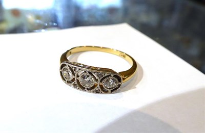 Lot 581 - A diamond plaque ring, three old cut diamonds within a border of rose cut diamonds, finger size...