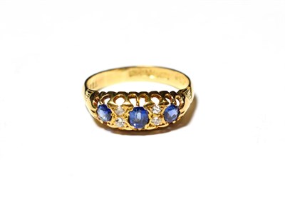 Lot 582 - An 18 carat gold sapphire and diamond ring, finger size P1/2