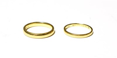Lot 592 - An 18 carat gold band ring, finger size M; and another band ring, marks rubbed, finger size L