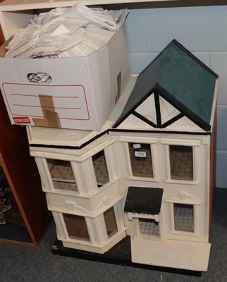 Lot 632 - A painted wooden two storey dolls town house with glazed windows and a small quantity of...