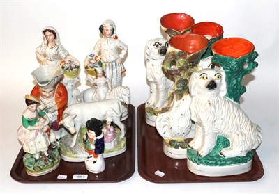 Lot 667 - Two trays of 19th century Staffordshire flat back figures, spill vases and Toby jugs, figures etc