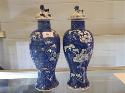 Lot 675 - A pair of early 20th century Chinese blue and white prunus and cracked ice baluster vases and...