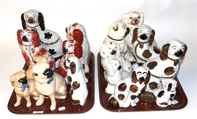 Lot 697 - Two trays of 19th century Staffordshire seated spaniels and pugs