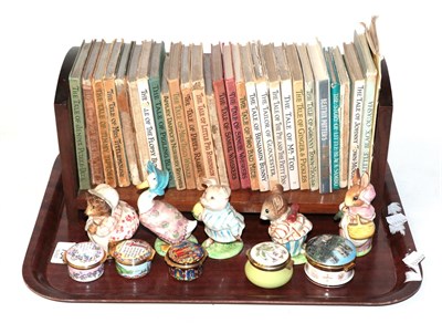 Lot 734 - A group of Beatrix Potter books, five Beswick Beatrix Potter models, three Halcyon Days enamel...