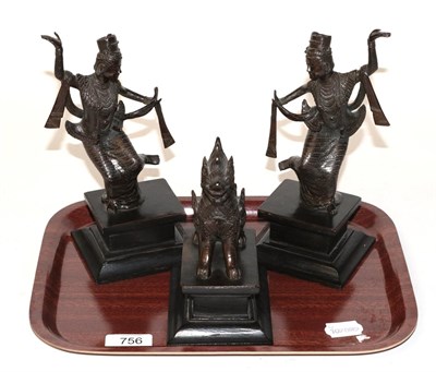 Lot 756 - Three South East Asian bronzes, comprising a pair of dancers and a temple lion (3)