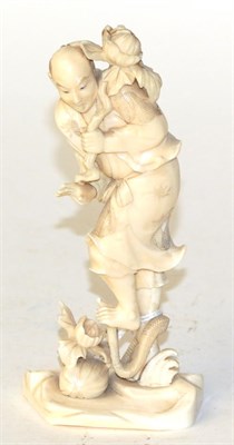 Lot 825 - A Japanese ivory okimono, man holding a flower, circa 1900