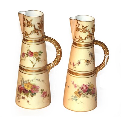 Lot 847 - A matched pair of Royal Worcester blush Ivory painted and gilt decorated water jugs, pattern no...