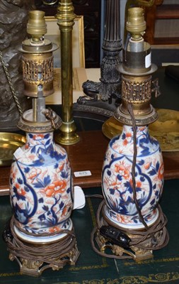 Lot 876 - A pair of Japanese Imari porcelain table lamps