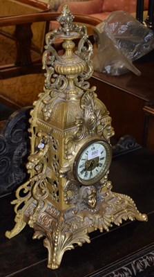 Lot 880 - A gilt metal striking mantel clock