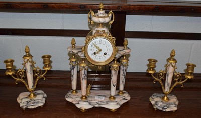 Lot 882 - A French marble striking portico mantel clock with garniture