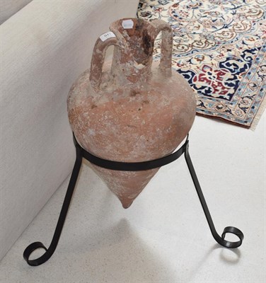 Lot 947 - A terracotta wine pot on black painted metal stand