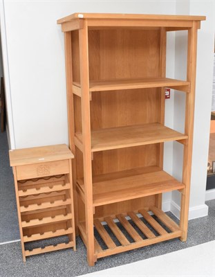 Lot 1116 - A modern oak free standing bookcase and bottle rack