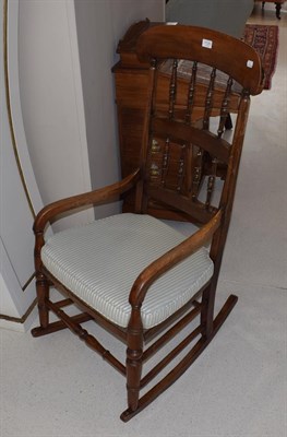 Lot 1125 - A mahogany rocking chair with turned spindle uprights