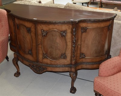 Lot 1138 - A carved mahogany serpentine fronted sideboard