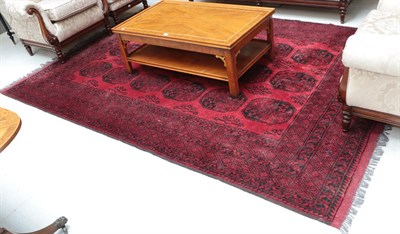 Lot 1145 - An Afghan red ground elephant foot print carpet