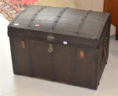 Lot 1153 - A dome topped metal mounted leather trunk