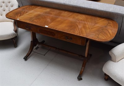 Lot 1156 - A reproduction mahogany and crossbanded sofa table in the Regency style
