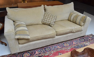 Lot 1160 - A modern three-seater sofa in pale corduroy fabric
