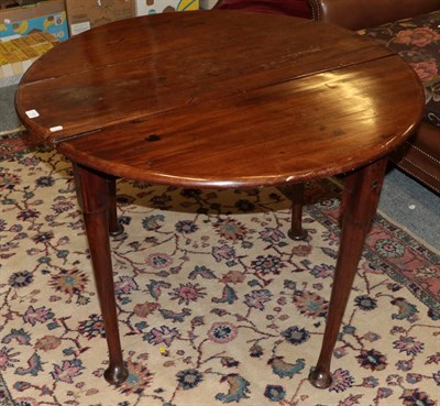 Lot 1193 - An 18th century mahogany drop leaf table on pad feet