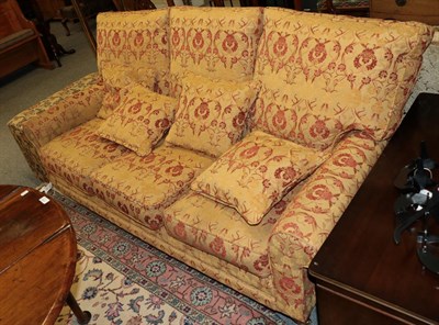 Lot 1195 - A cottage sofa upholstered in gold floral fabric