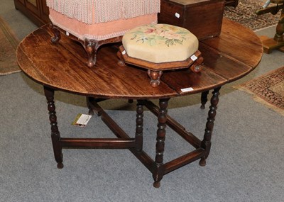 Lot 1205 - A joined oak six-seater drop-leaf dining table, circa 1700, with baluster bobbin turned legs joined