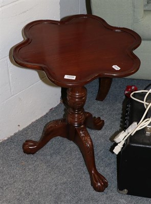 Lot 1209 - A reproduction carved tripod table