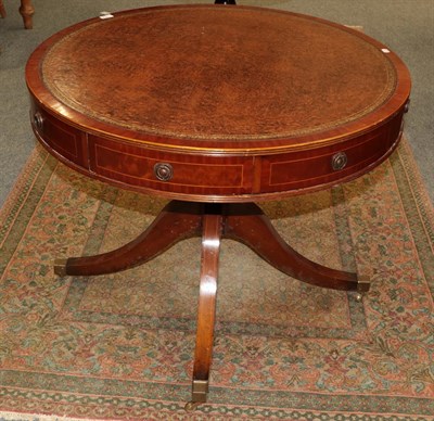 Lot 1218 - A reproduction library drum table with a brown leather top in the Georgian style