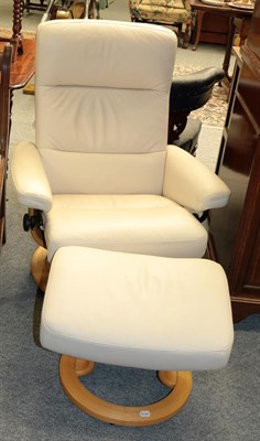 Lot 1235 - A Stressless cream leather reclining chair and footstool