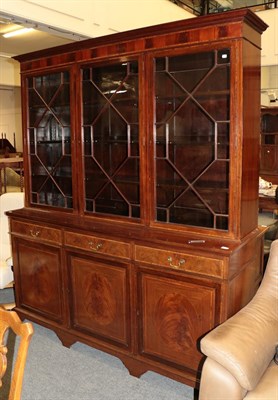 Lot 1242 - An inlaid and crossbanded mahogany astragal glazed triple bookcase; together with a large blue rug
