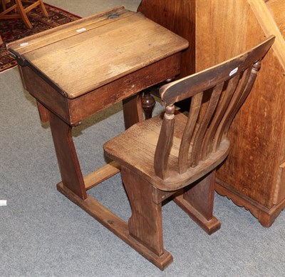 Lot 1246 - An oak and elm school room desk with integral chair, together with an oak bureau (2)