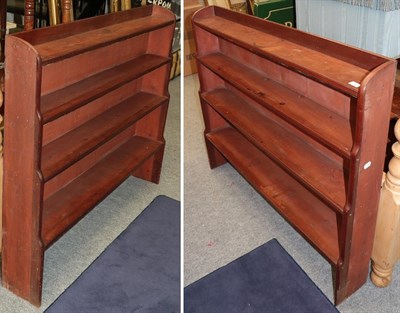 Lot 1260 - A pair of stained pine four-tier waterfall bookcases