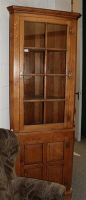 Lot 1272 - A well made Georgian style oak glazed and panelled standing corner cupboard (en suite to...