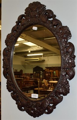 Lot 1310 - A 19th century carved oak mirror