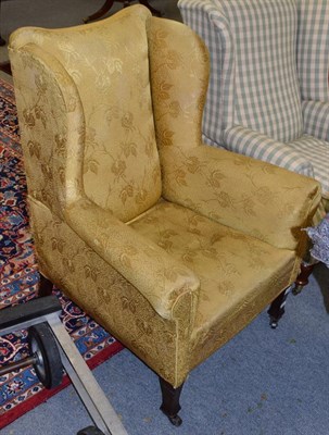 Lot 1323 - A late 19th century wing back chair upholstered in yellow fabric