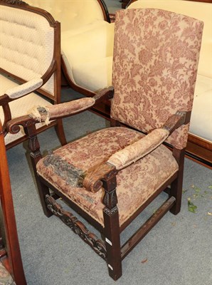 Lot 1344 - A boldly carved oak part-upholstered open armchair