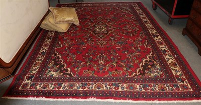 Lot 1346 - Hamadan carpet, the deep raspberry field centred by an indigo medallion framed by ivory...