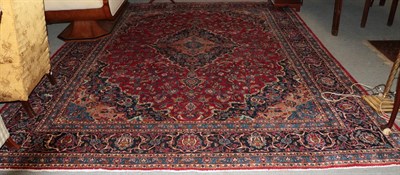 Lot 1347 - Mashad carpet, the raspberry field of vines around an indigo medallion framed by spandrels and...