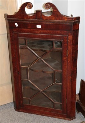 Lot 1373 - A George III oak astragal hanging corner cupboard