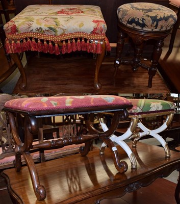 Lot 1374 - A late 19th century walnut dressing stool, with floral needlework cover on carved cabriole...