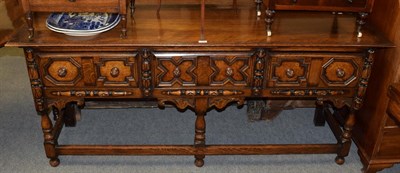 Lot 1404 - A 17th century style oak dresser with geometric moulded drawers