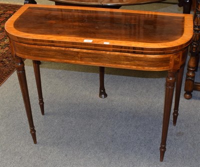 Lot 1407 - An early 19th century rosewood and satinwood banded fold over card table