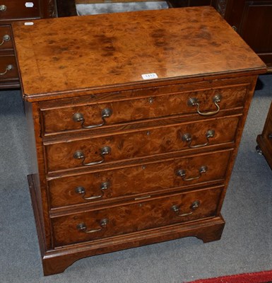 Lot 1413 - A reproduction burr wood four-drawer bachelors chest with a slide, 66cm wide